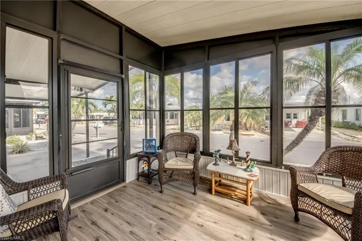 Sunroom with plenty of natural light and wood finished floors