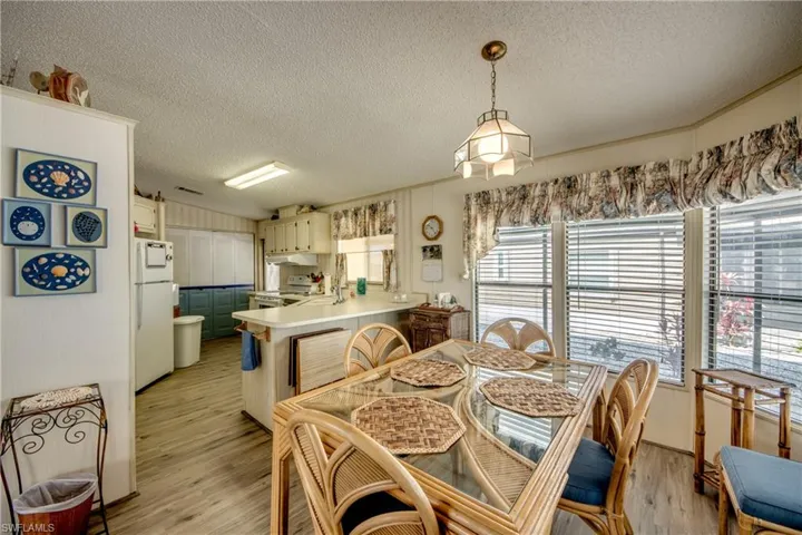 Dining space with a textured ceiling and light wood-style flooring