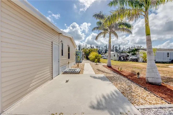 View of property exterior featuring a patio area and a residential view