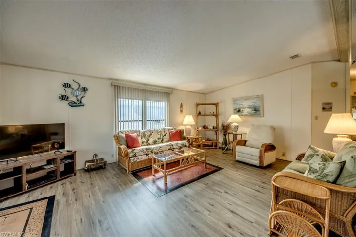 Living room featuring a textured ceiling and wood finished floors