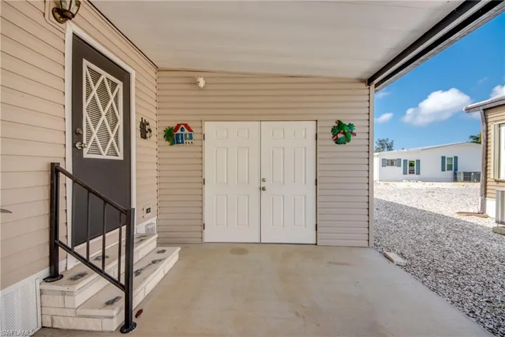 Property entrance with a patio area