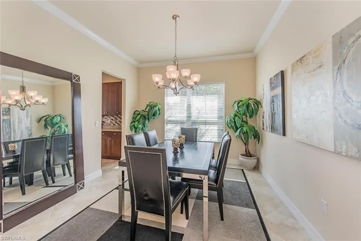 Dining area with a chandelier and crown molding