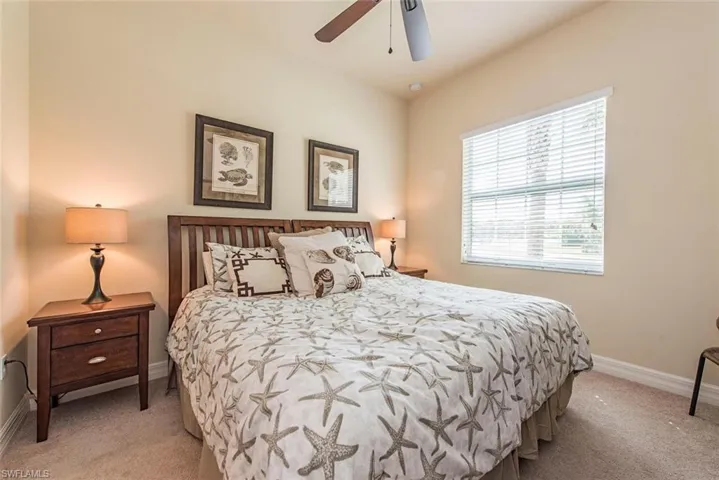Bedroom featuring a ceiling fan and light carpet