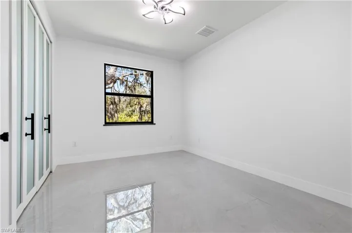 Unfurnished bedroom featuring baseboards and multiple closets