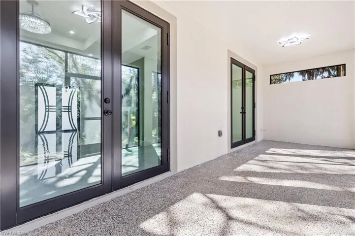 Entrance to property featuring french doors, stucco siding, and a patio