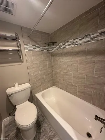 Bathroom with tub / shower combination and toilet