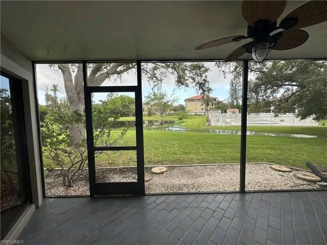Unfurnished sunroom with a water view and ceiling fan