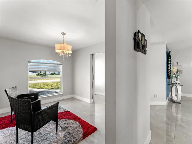 Sitting room featuring light marble finish flooring and a chandelier
