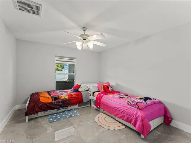 Bedroom with baseboards and ceiling fan