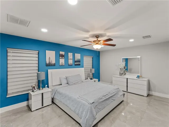 Bedroom featuring recessed lighting, a ceiling fan, and light marble finish floors