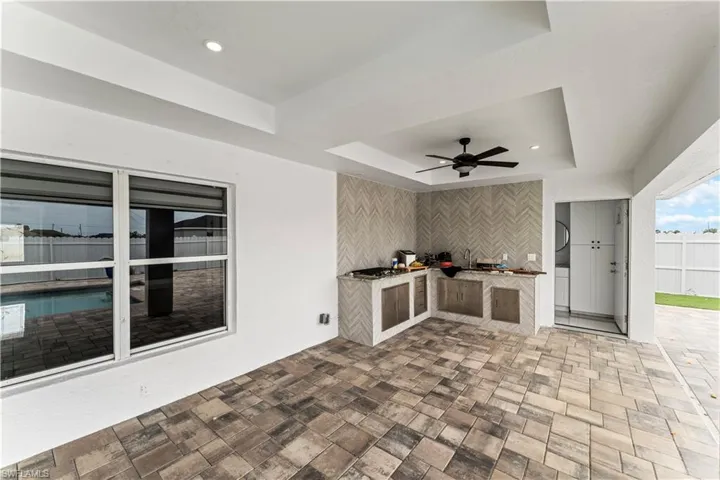 View of patio / terrace featuring area for grilling and ceiling fan