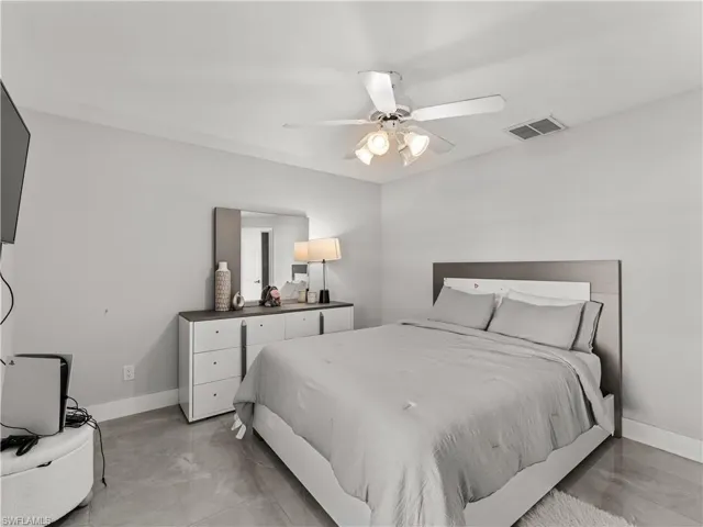 Bedroom with a ceiling fan and baseboards