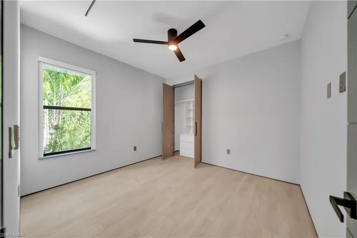 Light wood-finish flooring complements the neutral wall tones