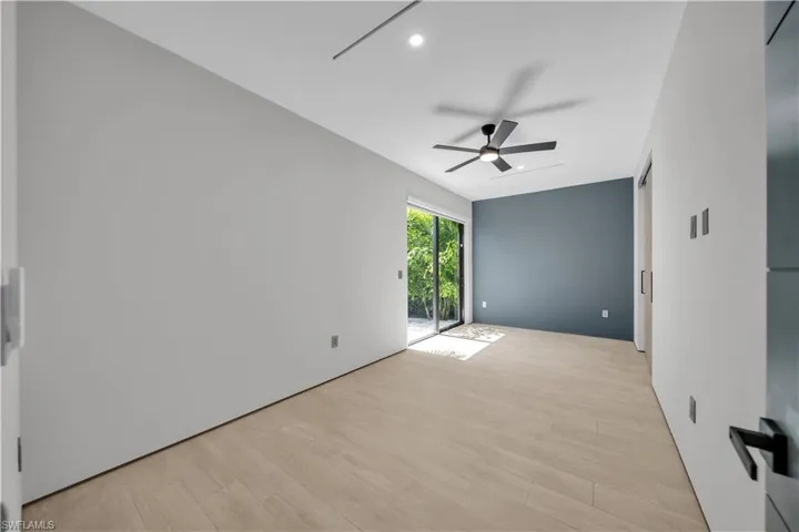 Light wood-finish flooring complemented by a feature wall in a deep matte finish