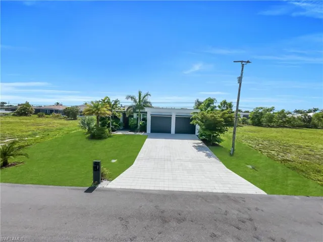 Modern single-story residence with a two-car garage and a paver driveway