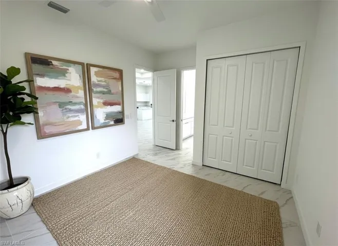 Unfurnished bedroom featuring a ceiling fan and a closet