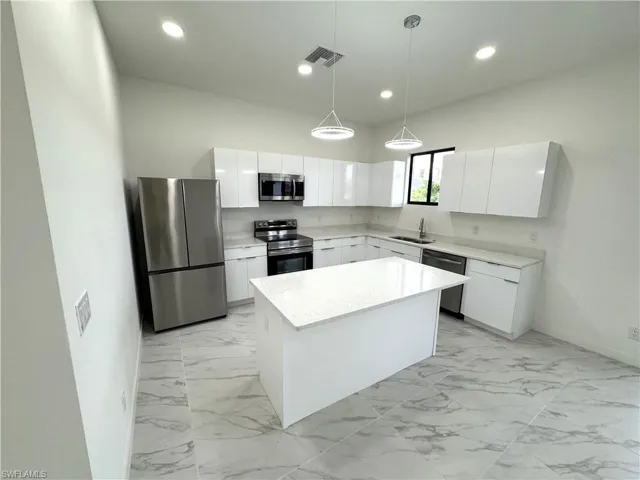 Kitchen with stainless steel appliances, white cabinetry, modern cabinets, pendant lighting, and recessed lighting