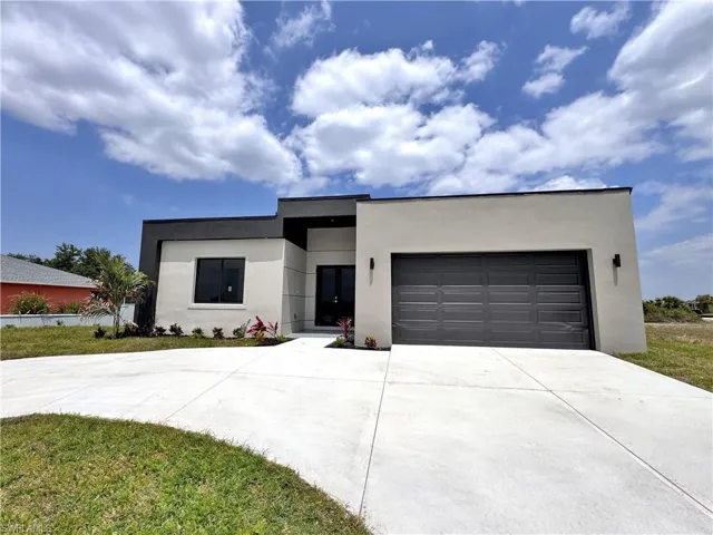 Contemporary home with stucco siding, concrete driveway, and an attached garage