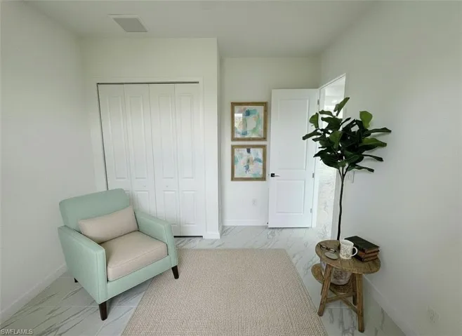 Sitting room featuring light marble finish floors