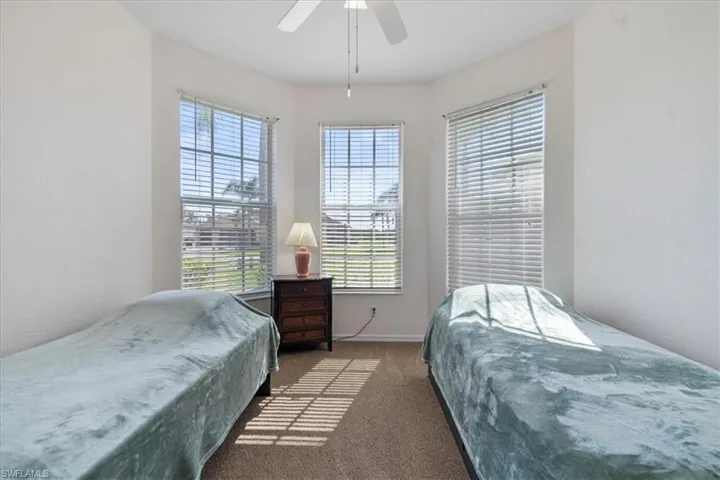 Carpeted bedroom with ceiling fan