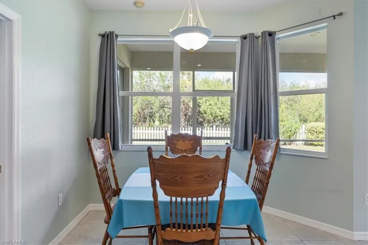 Tiled dining room featuring a wealth of natural light