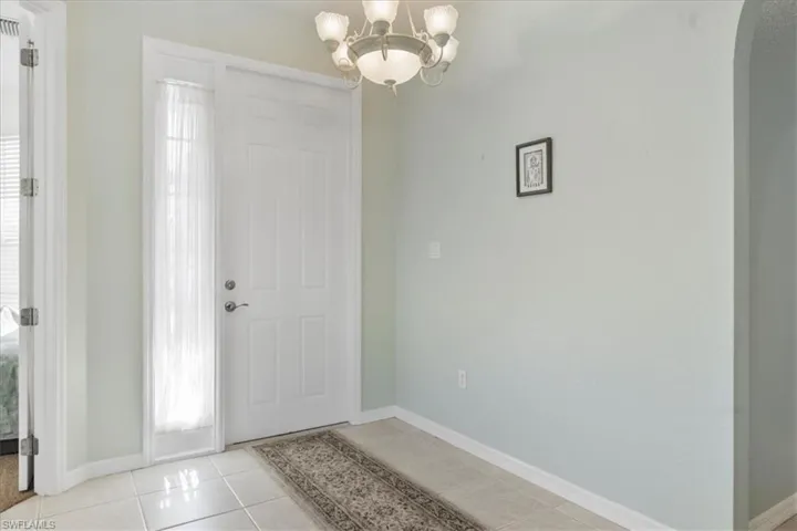 Foyer featuring an inviting chandelier and light tile patterned floors