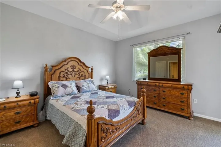 Carpeted bedroom with ceiling fan