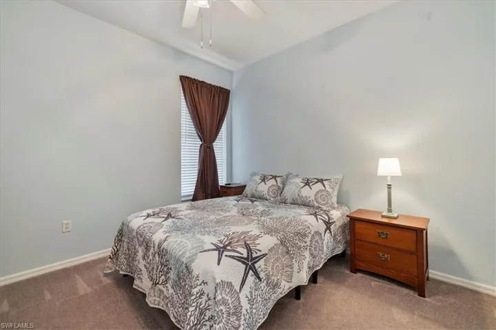 Bedroom featuring ceiling fan and carpet floors