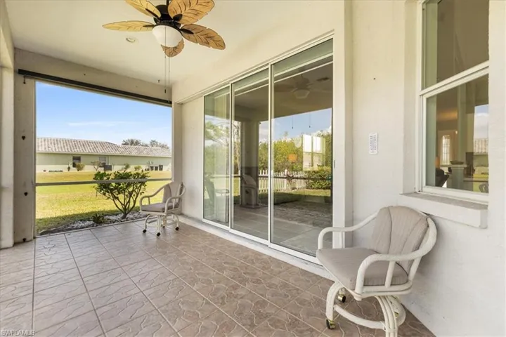 Sunroom / solarium with a wealth of natural light and ceiling fan