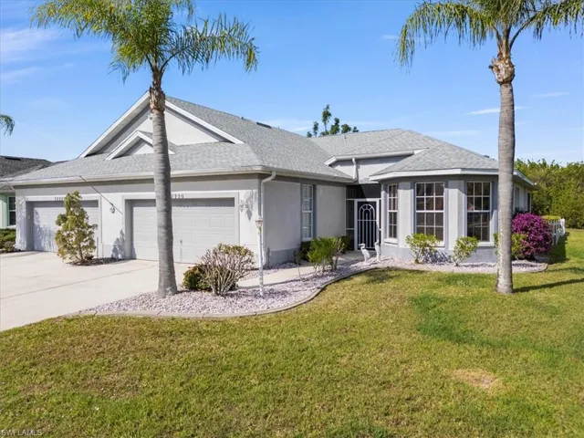 Ranch-style house with a garage and a front yard