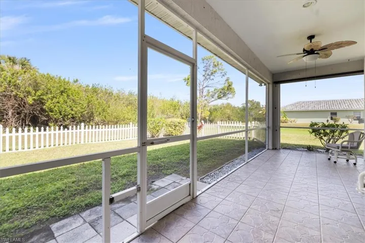 Unfurnished sunroom with ceiling fan