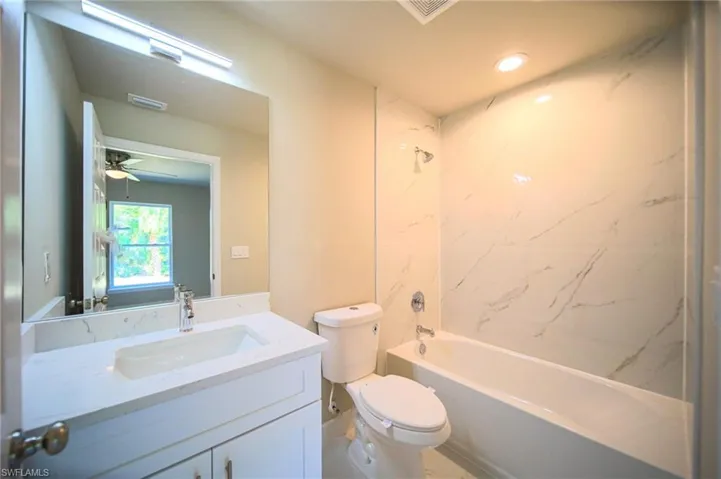 The Master Bath Has White Granite Countertop And A Tiled Tub Area!