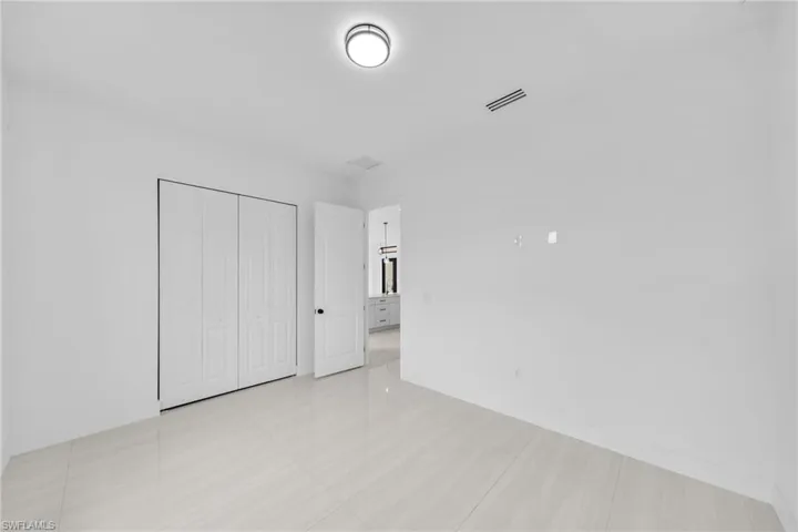Unfurnished bedroom featuring a closet and baseboards