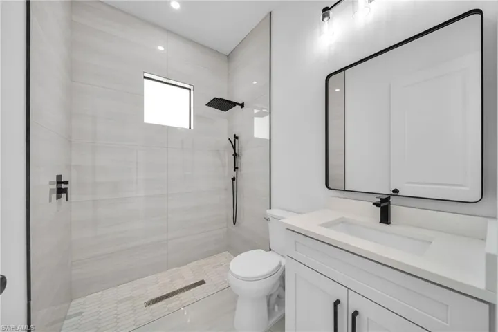 Full bathroom with a shower stall and vanity