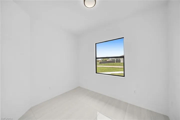 Empty room featuring baseboards