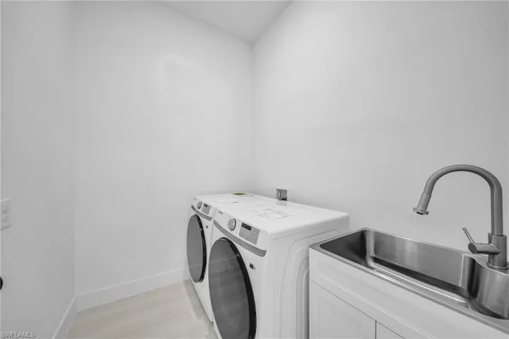 Laundry area featuring cabinet space and washing machine and dryer