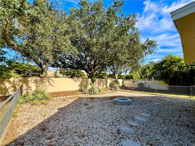 Fenced backyard with an outdoor fire pit