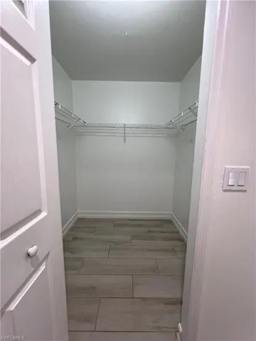 Walk in closet featuring light wood finished floors