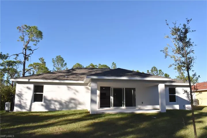 Back of property with a patio area and a yard