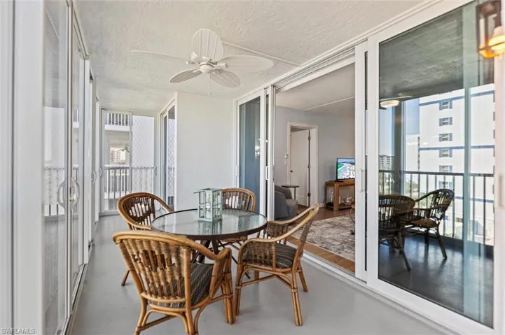 Sunroom with ceiling fan and outdoor dining area
