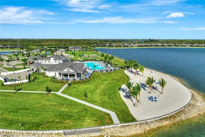 Aerial view of residential area with a large body of water and a pool