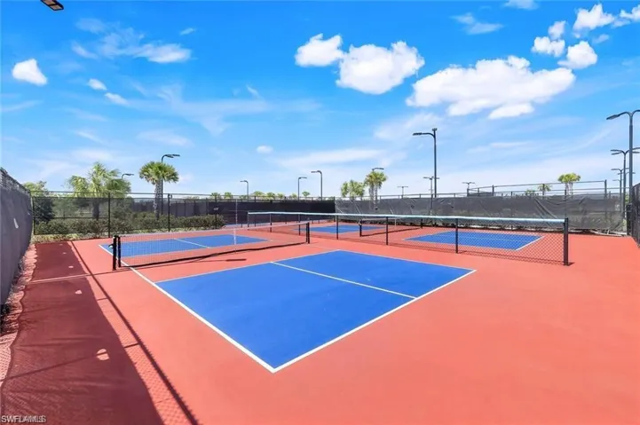 View of tennis court with community basketball court
