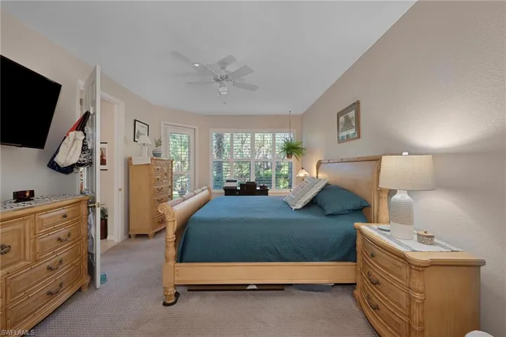 Bedroom featuring ceiling fan and light colored carpet