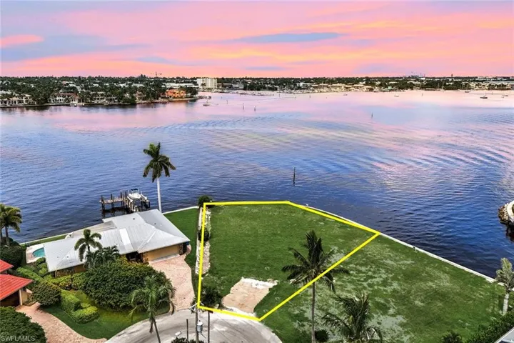 Aerial view at dusk featuring a water view