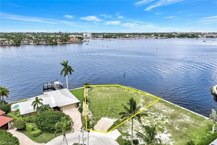 Birds eye view of property with a water view