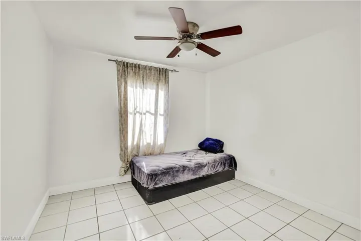 Bedroom featuring ceiling fan and light tile patterned floors