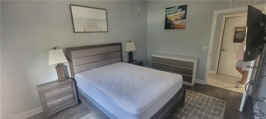 Wood-finish flooring throughout, featuring a neutral color palette and recessed lighting