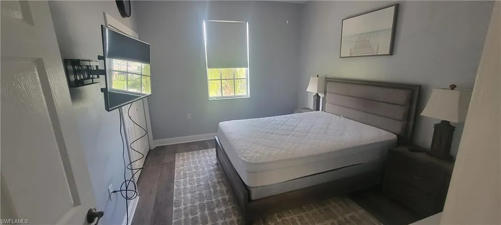 Interior room featuring wood-finish flooring and light gray painted walls