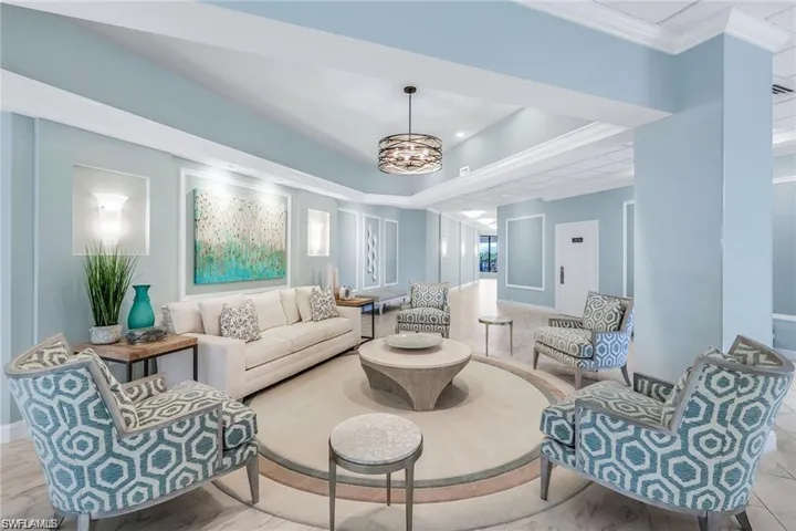 1st floor Sitting room with a chandelier, a raised ceiling, and ornamental molding