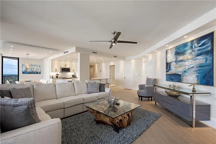 Living area featuring light wood-style flooring, a chandelier, recessed lighting, and a ceiling fan